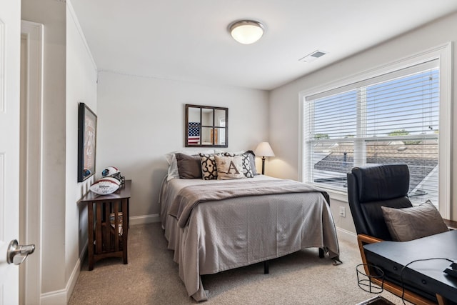 bedroom with carpet floors, visible vents, and baseboards