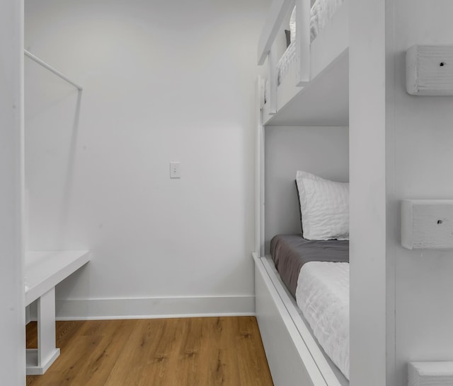 mudroom with baseboards and wood finished floors