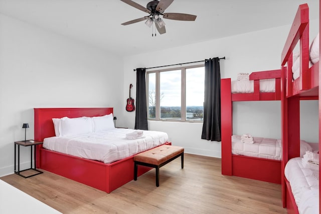 bedroom featuring ceiling fan, light wood-type flooring, and baseboards