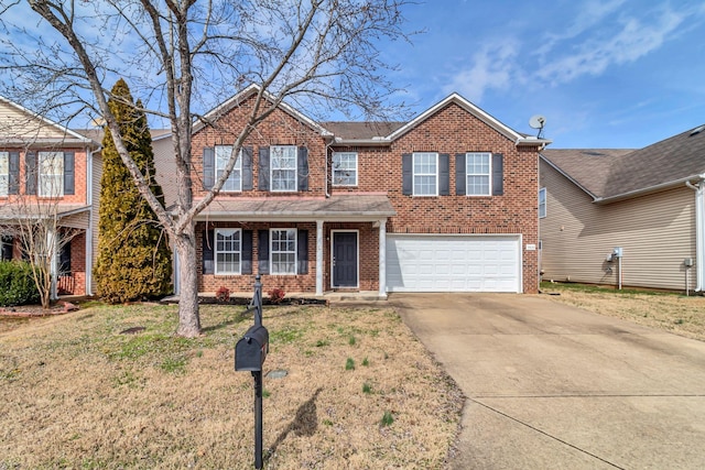 traditional home featuring a garage, concrete driveway, brick siding, and a front yard