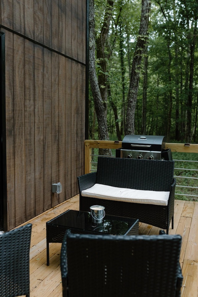 wooden deck featuring a grill