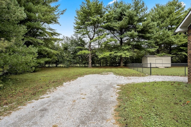 view of yard with an outdoor structure and fence