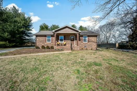 view of front of home featuring a front yard, crawl space, and brick siding