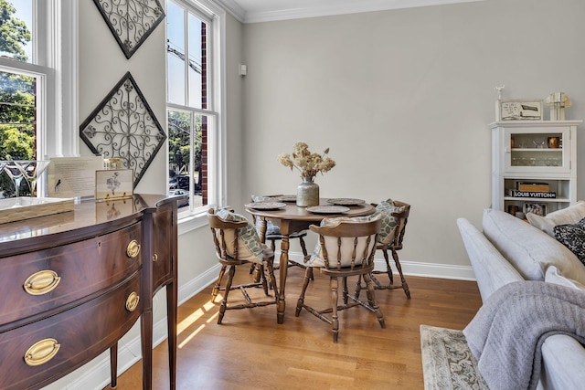 2112 Acklen Ave Unit 201, Nashville, TN 37212 - dining space with crown molding, baseboards, and light wood-style floors
