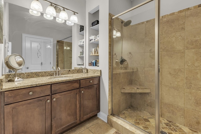 2112 Acklen Ave Unit 201, Nashville, TN 37212 - full bathroom with a shower stall, built in shelves, tile patterned flooring, and vanity