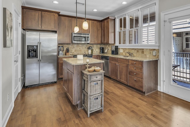 2112 Acklen Ave Unit 201, Nashville, TN 37212 - kitchen featuring light stone countertops, stainless steel appliances, a kitchen island, decorative backsplash, and decorative light fixtures