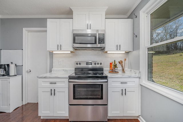 kitchen featuring white cabinets, stainless steel appliances, and crown molding