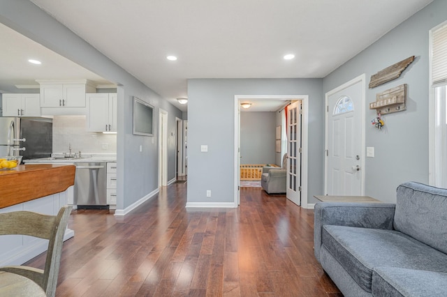 interior space with dark wood-style floors, baseboards, and recessed lighting