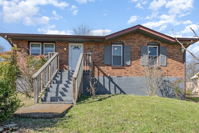 ranch-style home featuring a front lawn, crawl space, and brick siding