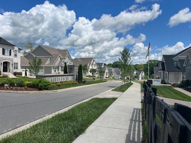 view of road with a residential view, curbs, and sidewalks