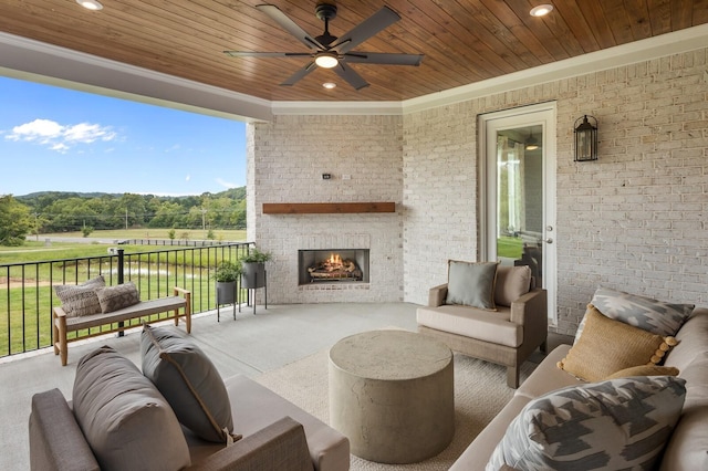 view of patio / terrace featuring an outdoor living space with a fireplace and ceiling fan