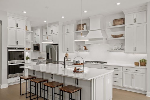 kitchen with open shelves, custom exhaust hood, stainless steel appliances, light countertops, and white cabinets