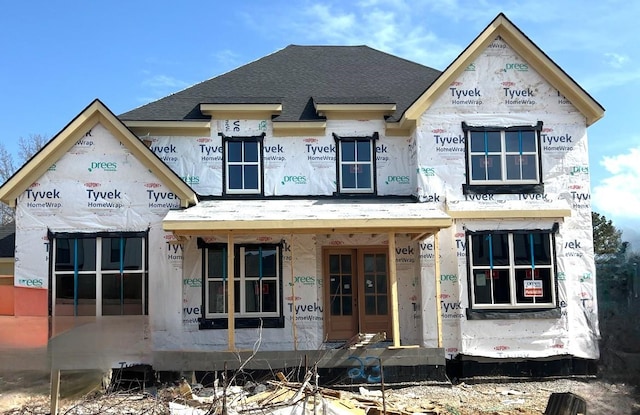 property under construction featuring roof with shingles