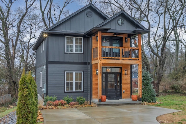 view of front of property featuring board and batten siding and a balcony