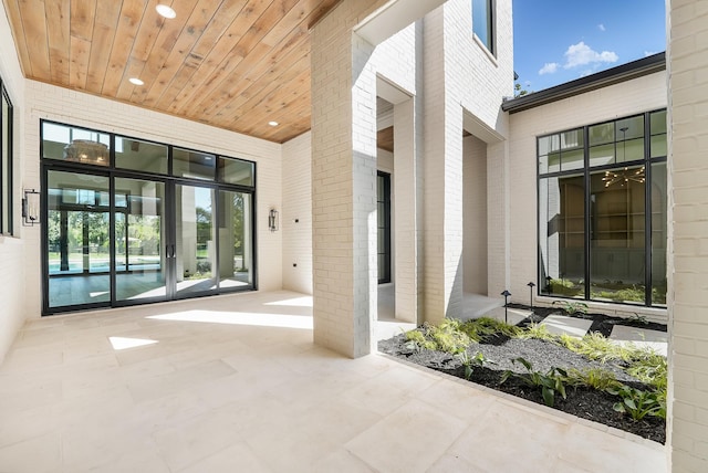 doorway to property featuring brick siding