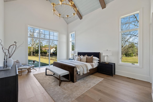 bedroom with high vaulted ceiling, access to outside, multiple windows, and light wood-style flooring