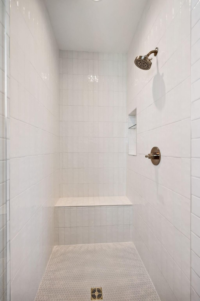 bathroom with tiled shower