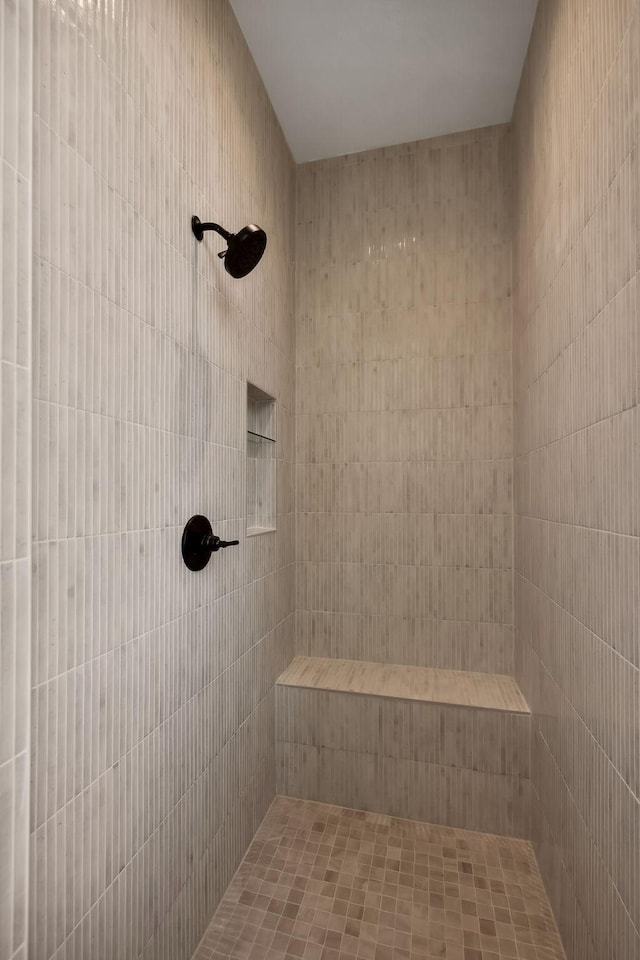 bathroom with a tile shower and a sauna