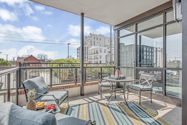 sunroom / solarium featuring a wealth of natural light and a city view