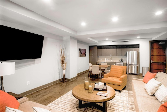 living room with recessed lighting and baseboards