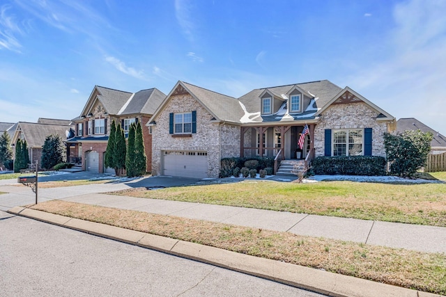 view of front of home featuring driveway, covered porch, a garage, and brick siding