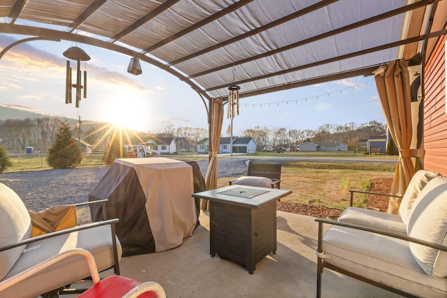 view of patio featuring a residential view, grilling area, and a pergola