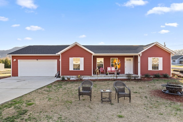 single story home with concrete driveway, roof with shingles, an attached garage, and covered porch