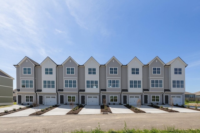 multi unit property with concrete driveway and a residential view