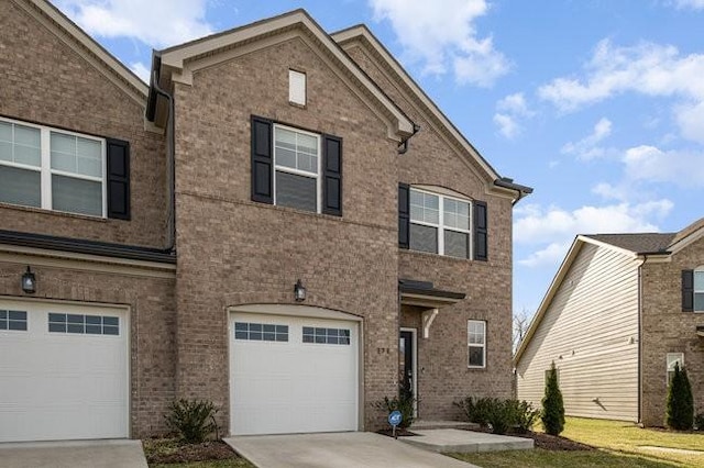 view of front of house featuring a garage, driveway, and brick siding