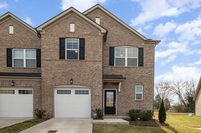 view of front of property featuring driveway, brick siding, an attached garage, and a front yard