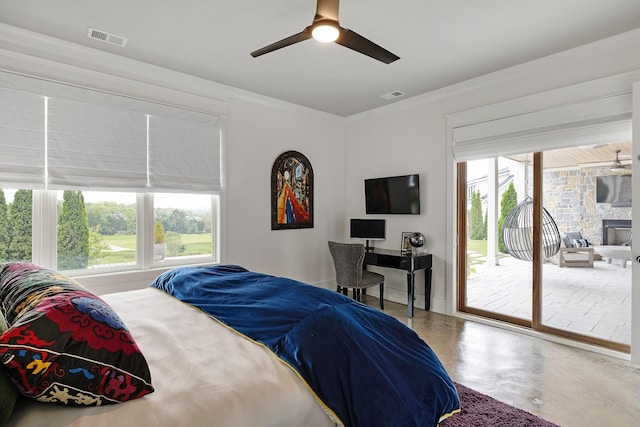 bedroom featuring access to exterior, visible vents, concrete floors, and multiple windows