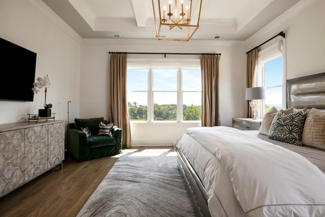 bedroom with dark wood-style floors, multiple windows, and visible vents