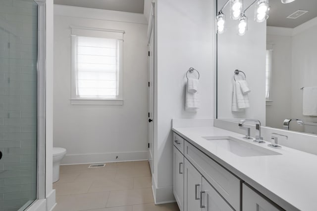 bathroom featuring toilet, baseboards, visible vents, and vanity