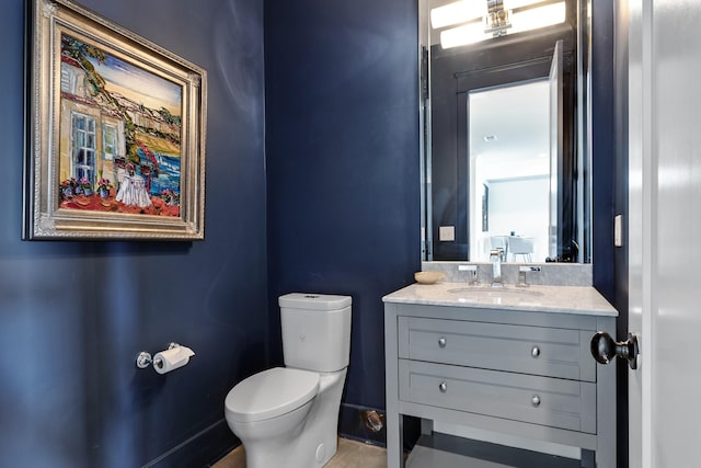 bathroom featuring toilet and vanity