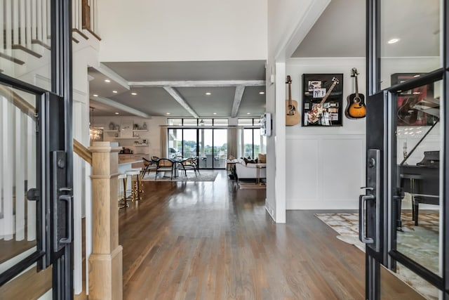 entrance foyer with wood finished floors and a decorative wall