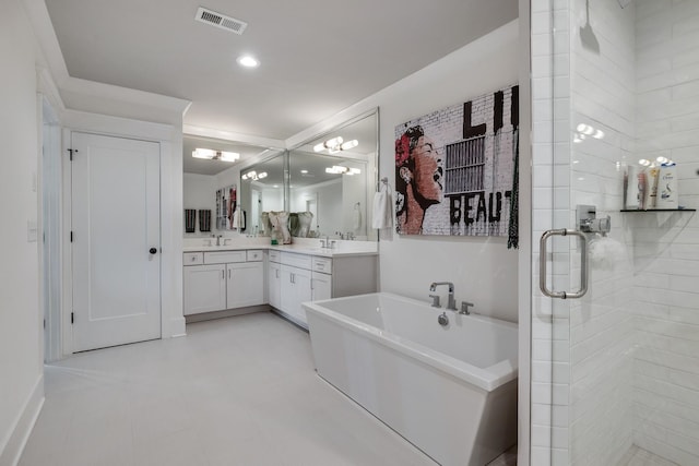 bathroom with a soaking tub, visible vents, a sink, and double vanity