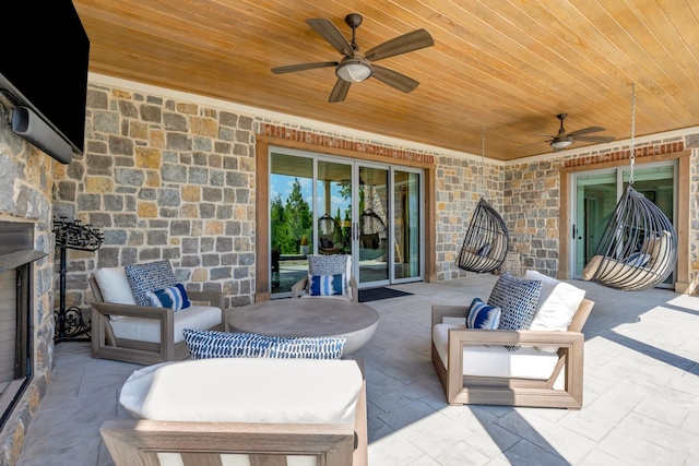 view of patio with an outdoor living space and a ceiling fan