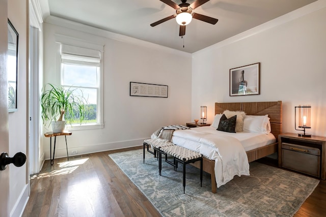 bedroom with baseboards, ornamental molding, ceiling fan, and dark wood-type flooring