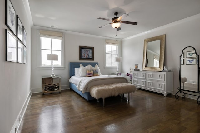 bedroom with a ceiling fan, baseboards, visible vents, dark wood finished floors, and crown molding