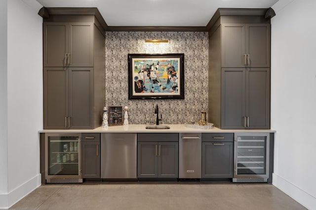 bar featuring beverage cooler, indoor wet bar, a sink, and baseboards