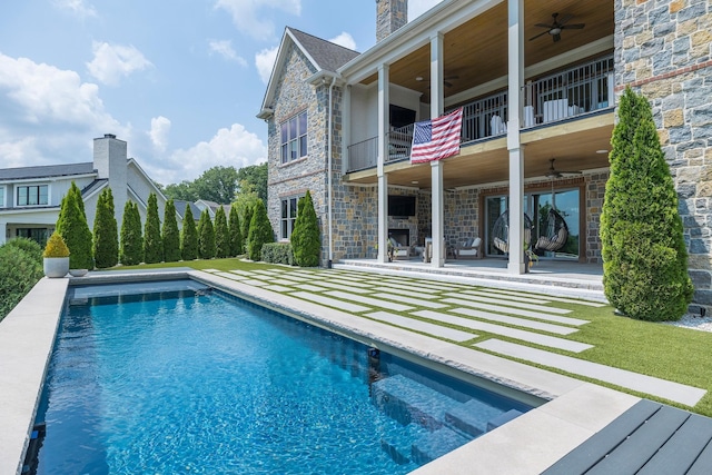 pool with a patio area and a ceiling fan