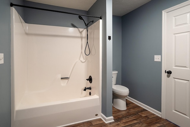 full bathroom with toilet, baseboards, wood finished floors, and shower / bathtub combination