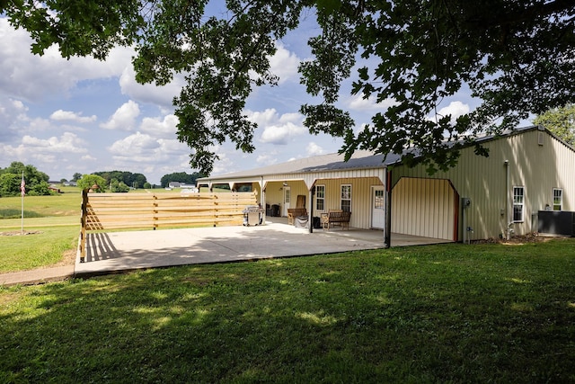 back of house with a lawn