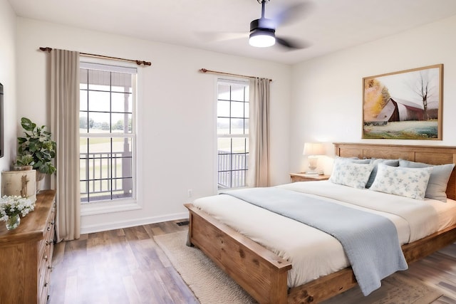 bedroom featuring ceiling fan, baseboards, and wood finished floors