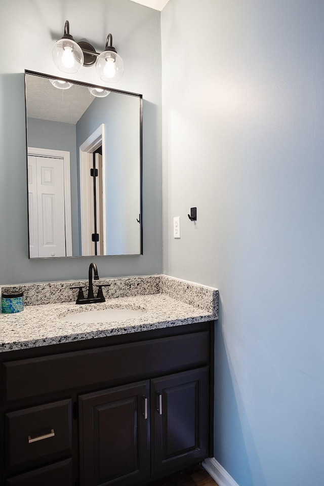 bathroom featuring vanity and baseboards