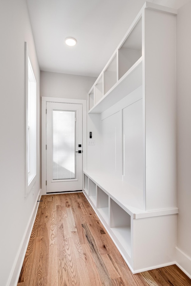 mudroom featuring light wood-style flooring and baseboards