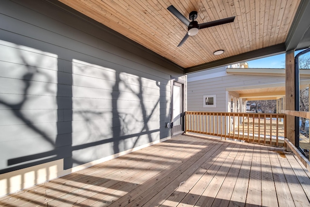 wooden deck featuring a ceiling fan