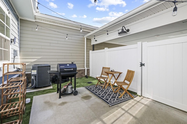 view of patio / terrace with central AC, fence, and grilling area