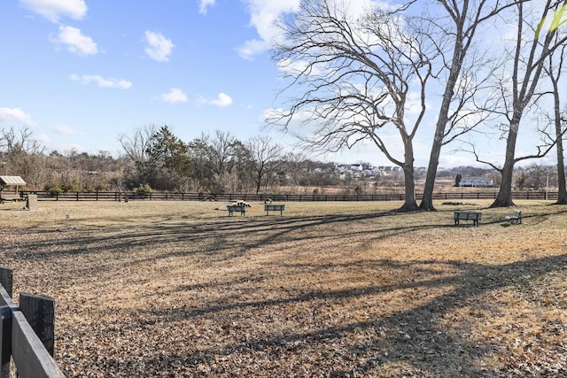 view of yard featuring fence and a rural view