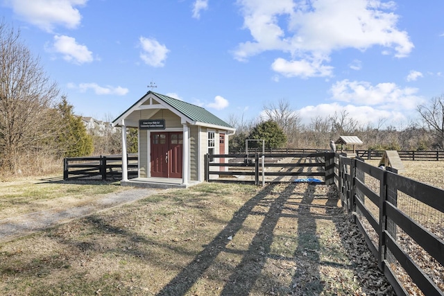 view of outdoor structure featuring a rural view and an outdoor structure